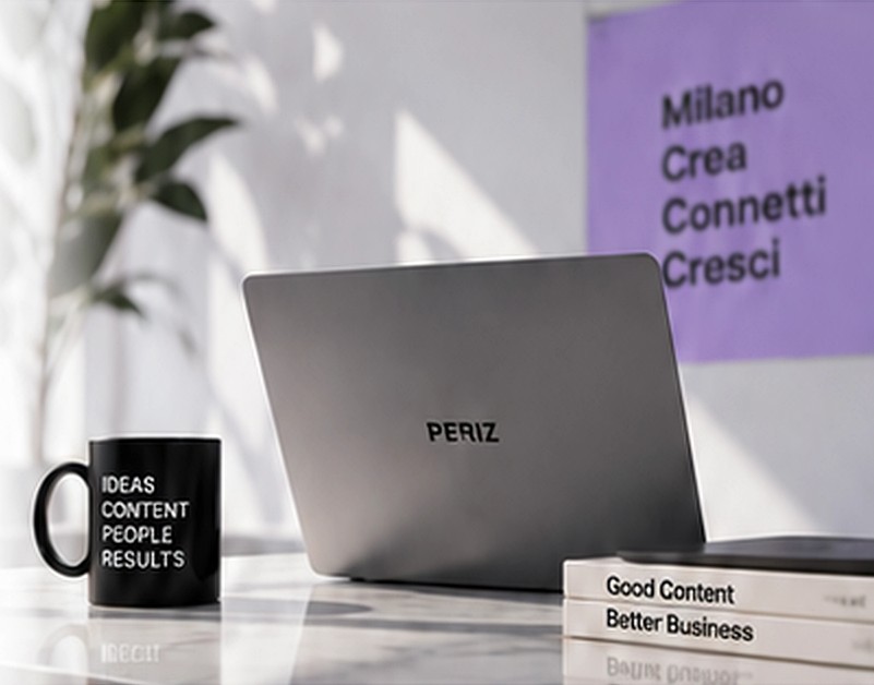 La scrivania di Periz Marketing: portatile, tazza e libri